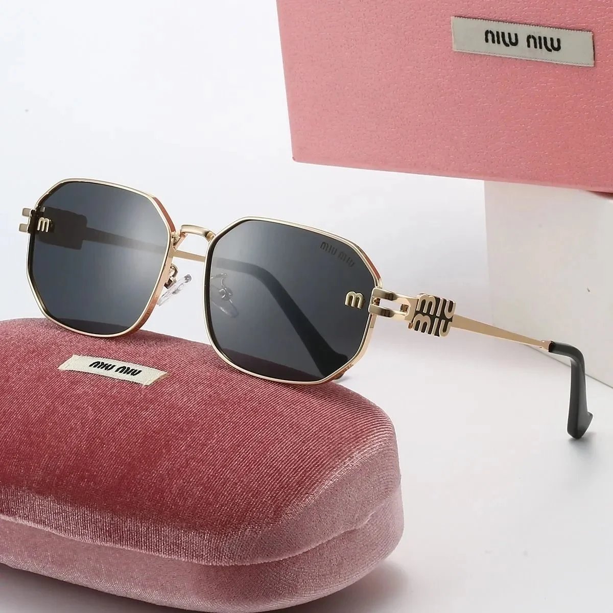 Miu Miu Gold Frame Sunglasses with Black Lenses