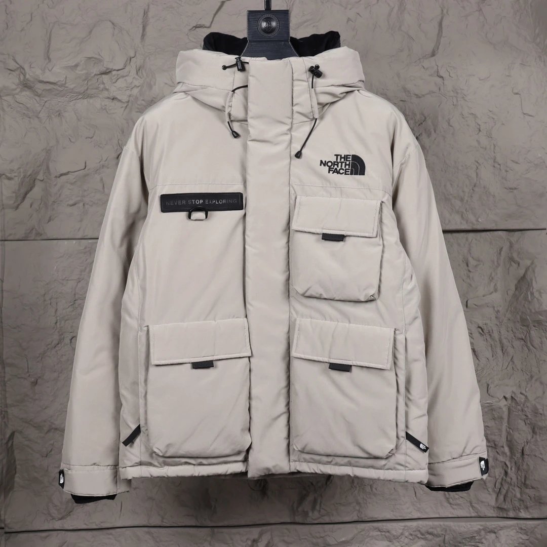 The North Face Beige Winter Jacket with Multiple Pockets and Hood